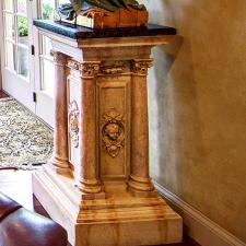Faux stone and marble top statue base embellishment